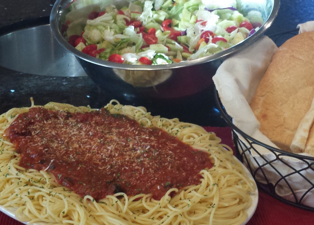 Monster Spaghetti, green Salad and garlic bread served family style.